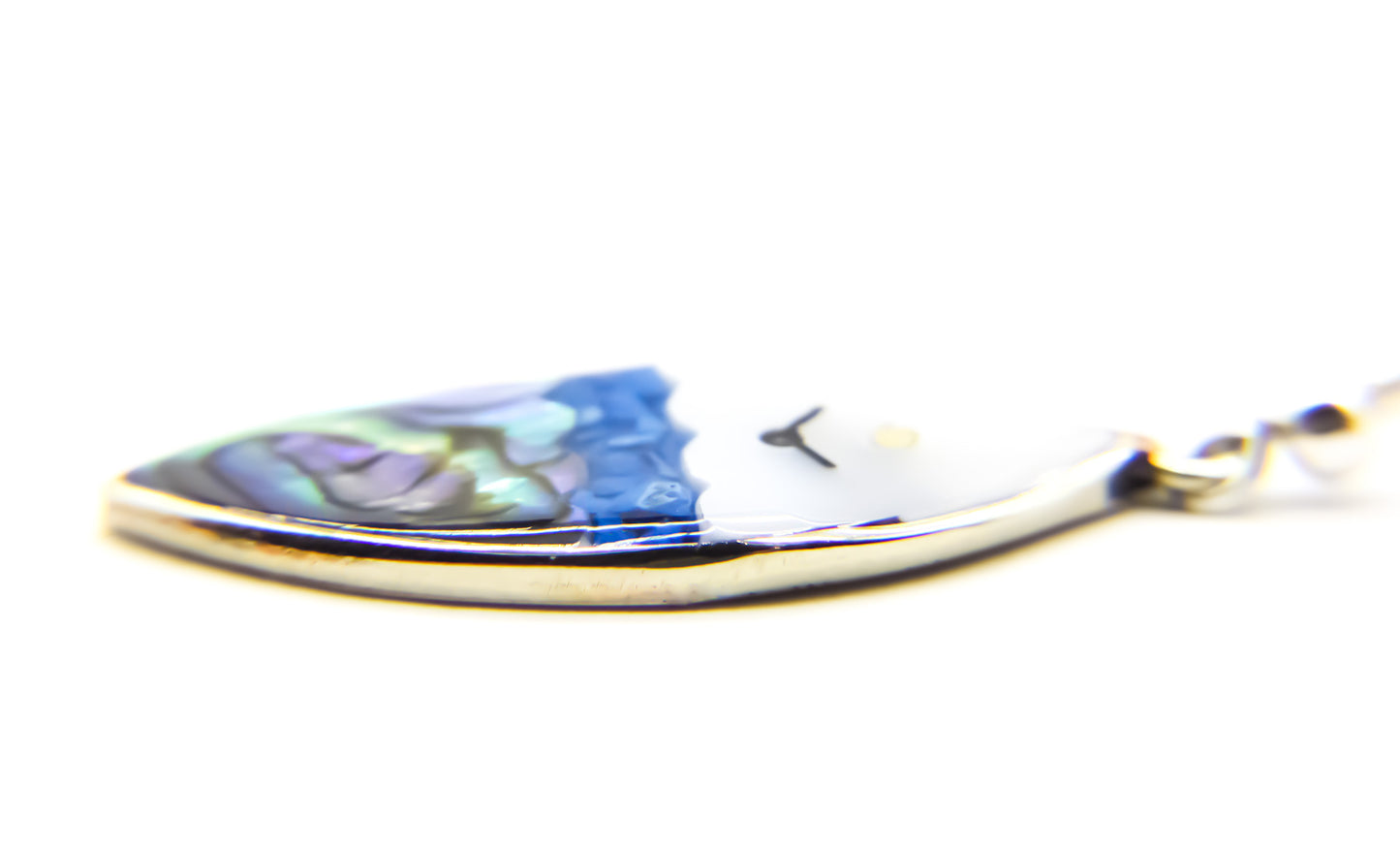 close-up of oval earring featuring an ocean view design