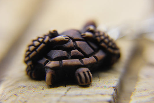 pendant of adult sea turtle with baby sea turtles