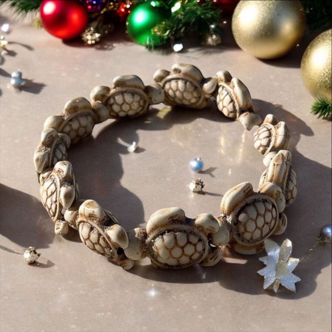 Cream sea turtle bracelet with Christmas baubles and decorations. 