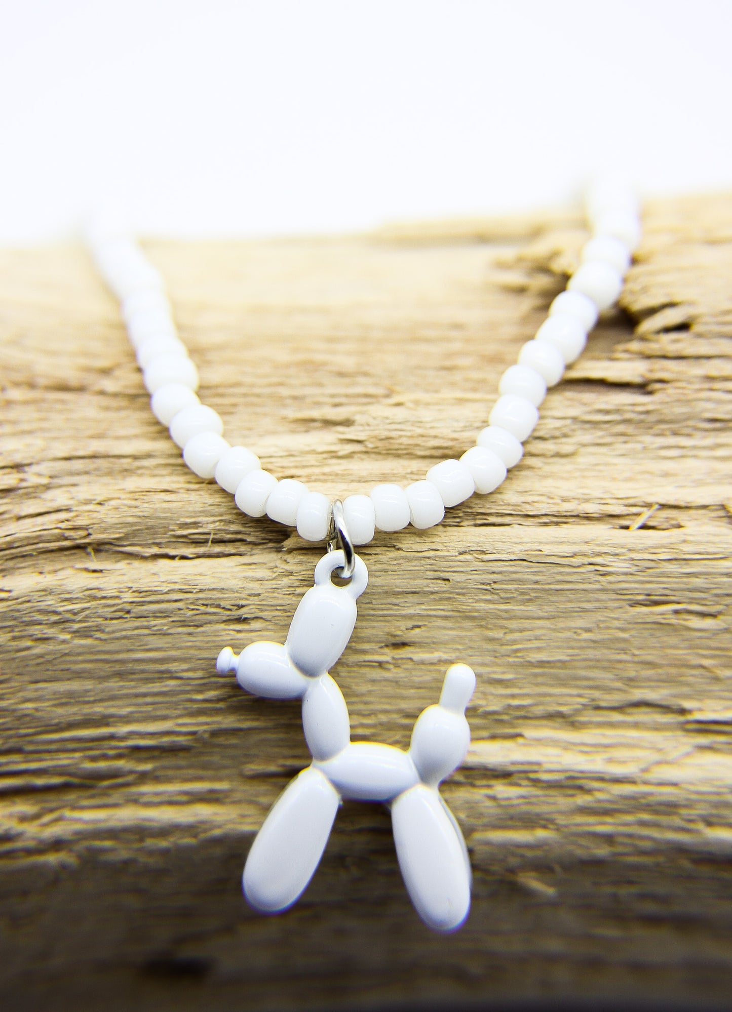 white beaded necklace with dog pendant