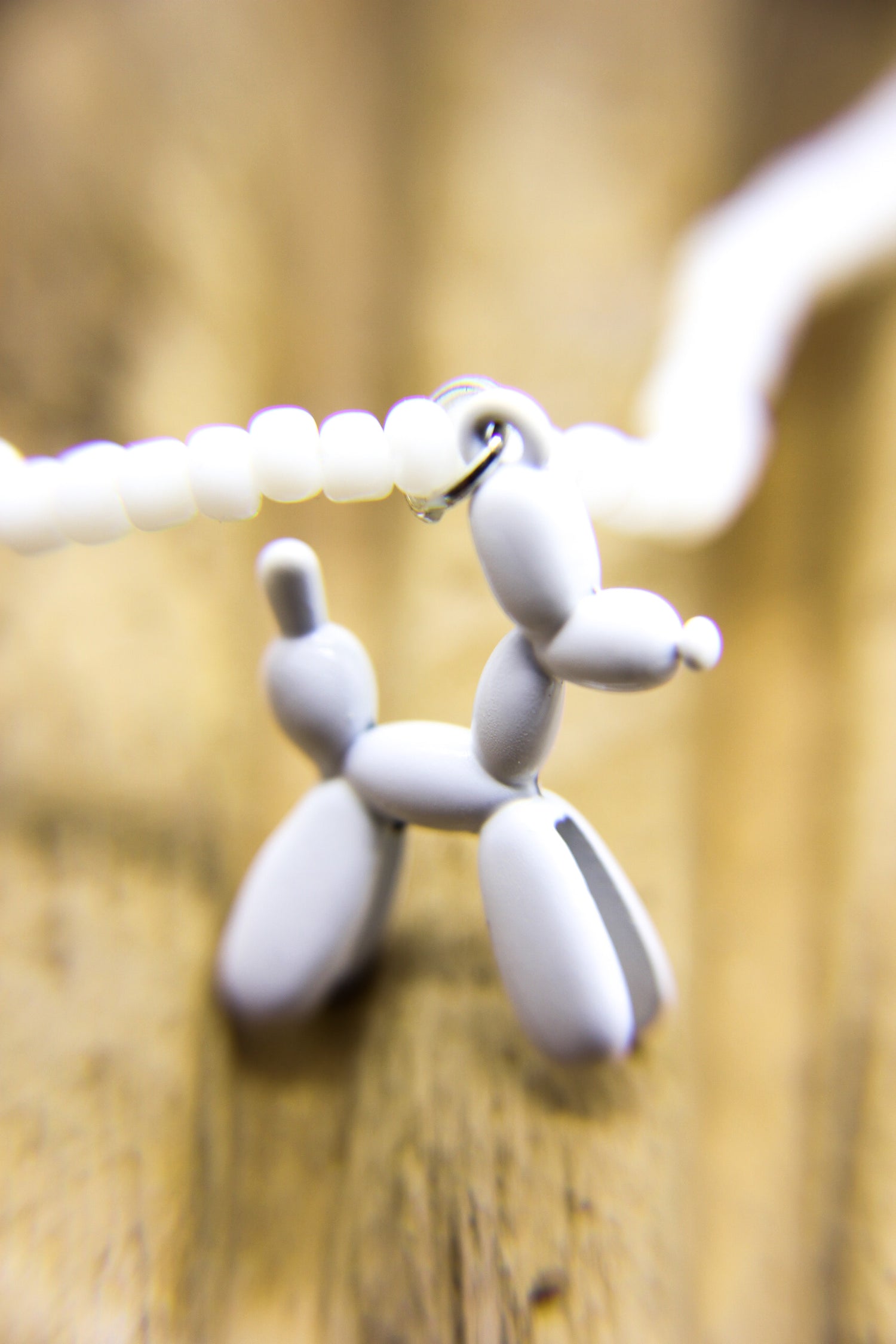 Close-up of white dog pendant