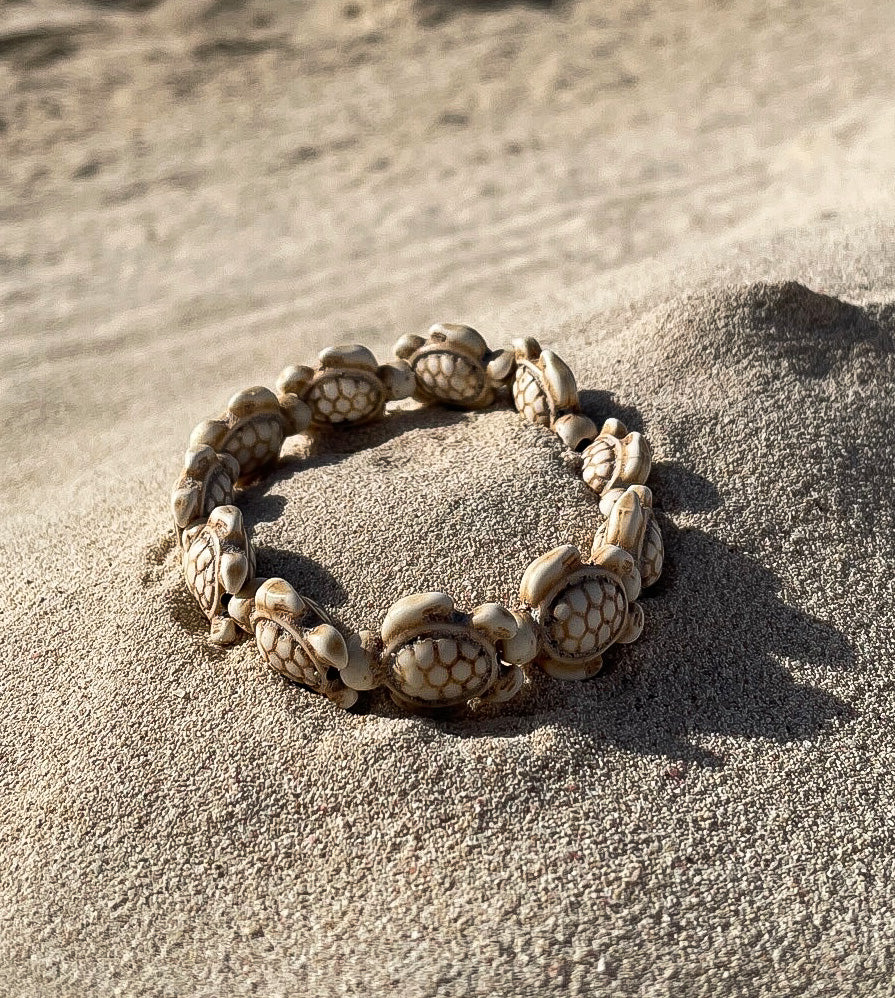 stone sea turtle bracelet on a beach - beach jewellery