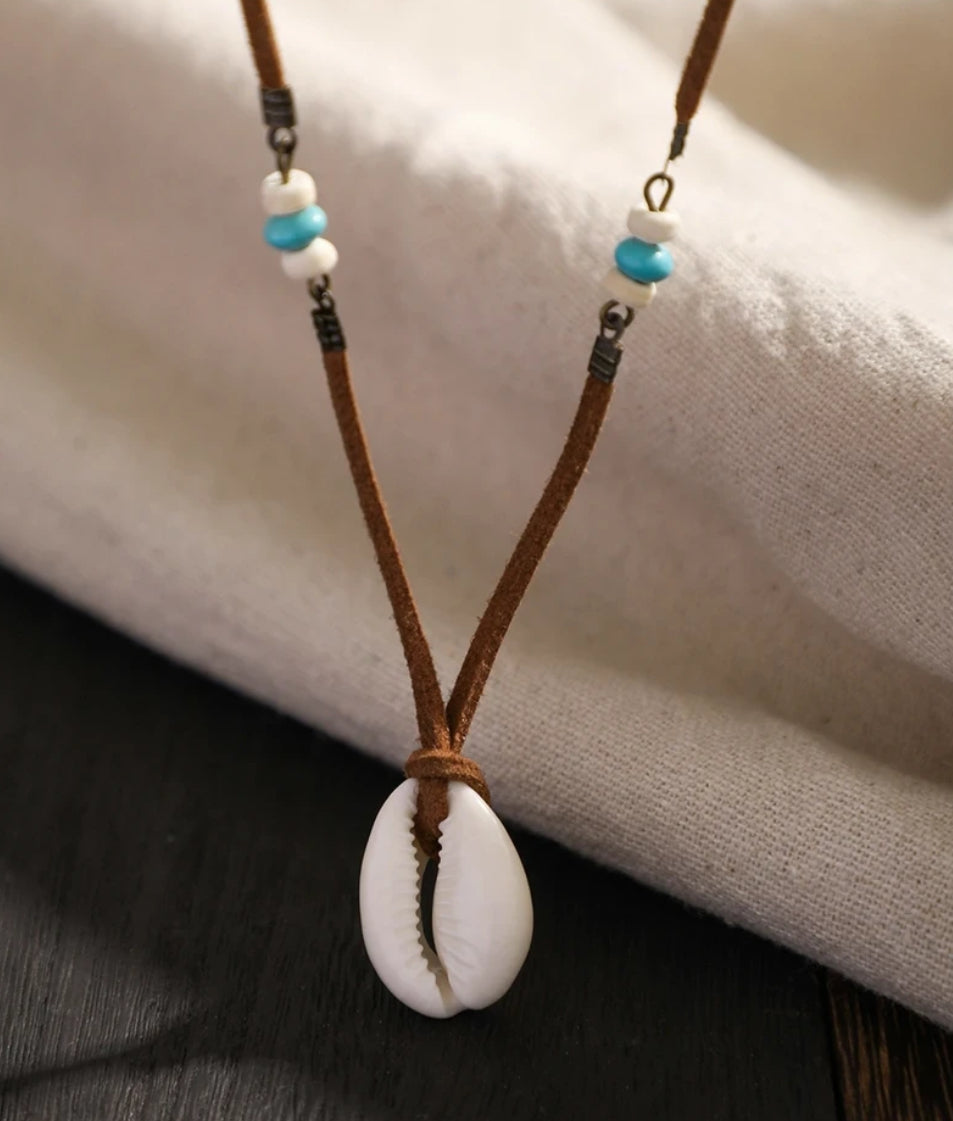 beach necklace in suede cord with white cowrie shell pendant