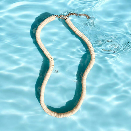 White shell necklace floating in water. Waterproof beach jewellery. 