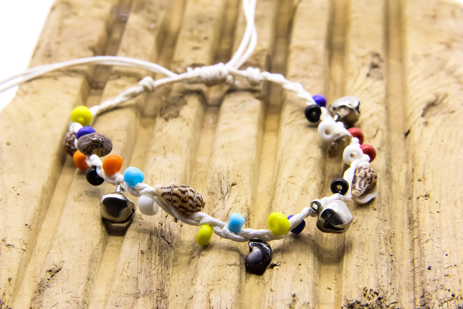 white string anklet with shells, beads and tiny bells. 