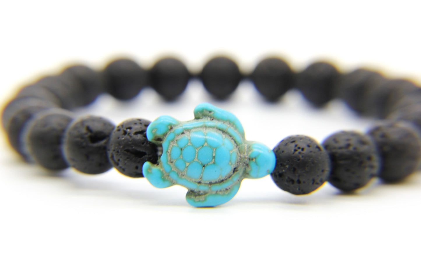 Black lava stone beach bracelet with turquoise sea turtle charm