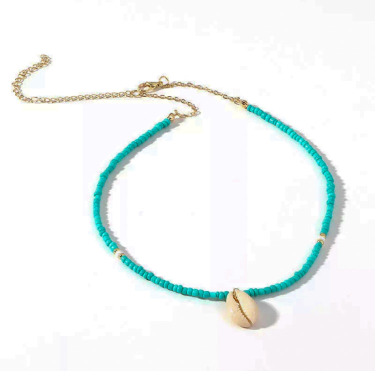 Turquoise beaded choker with white and brass beads and white seashell pendant 