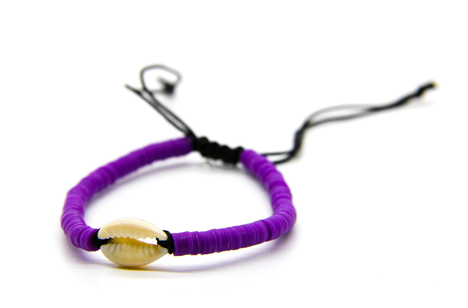 Purple braided bracelet with cream seashell pendant