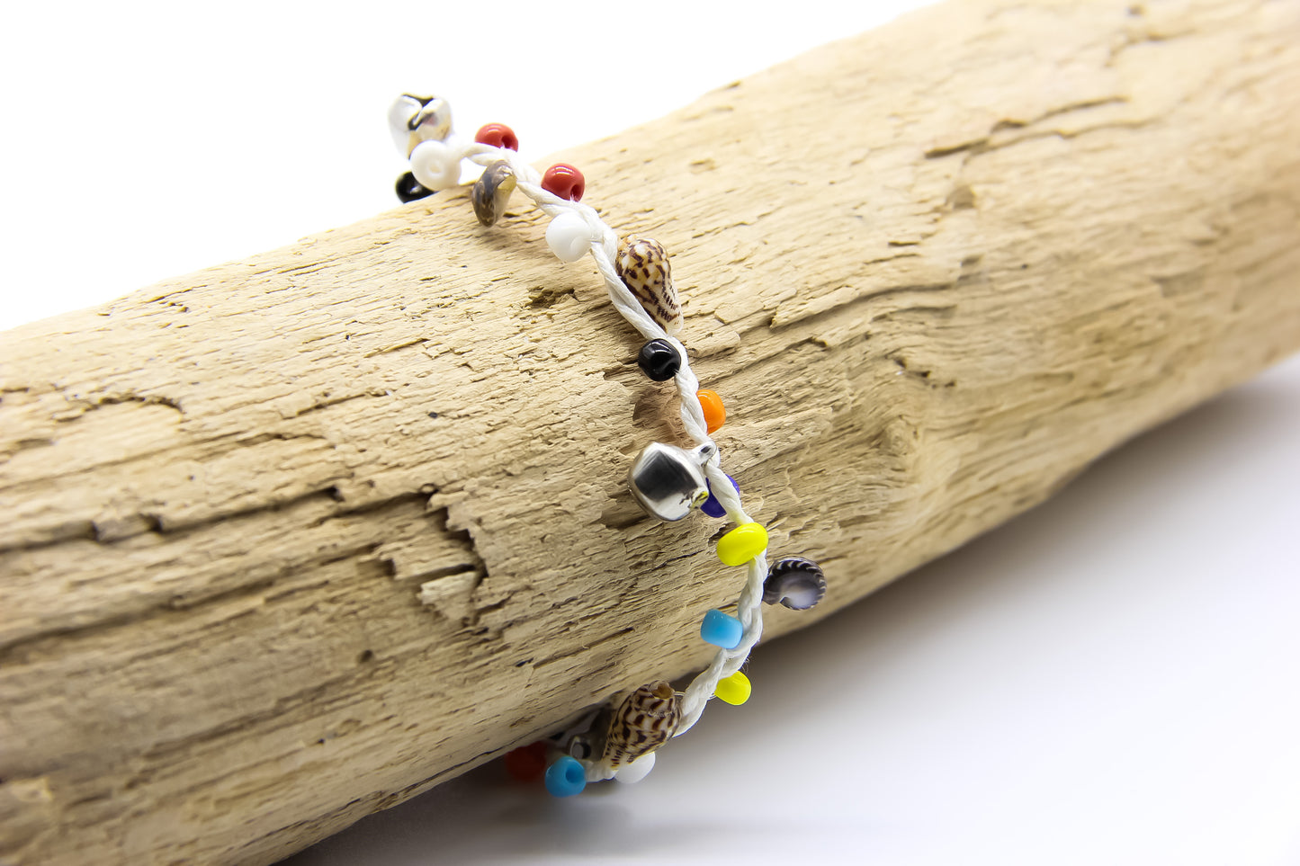 white string anklet with colourful beads, silver bells and shells