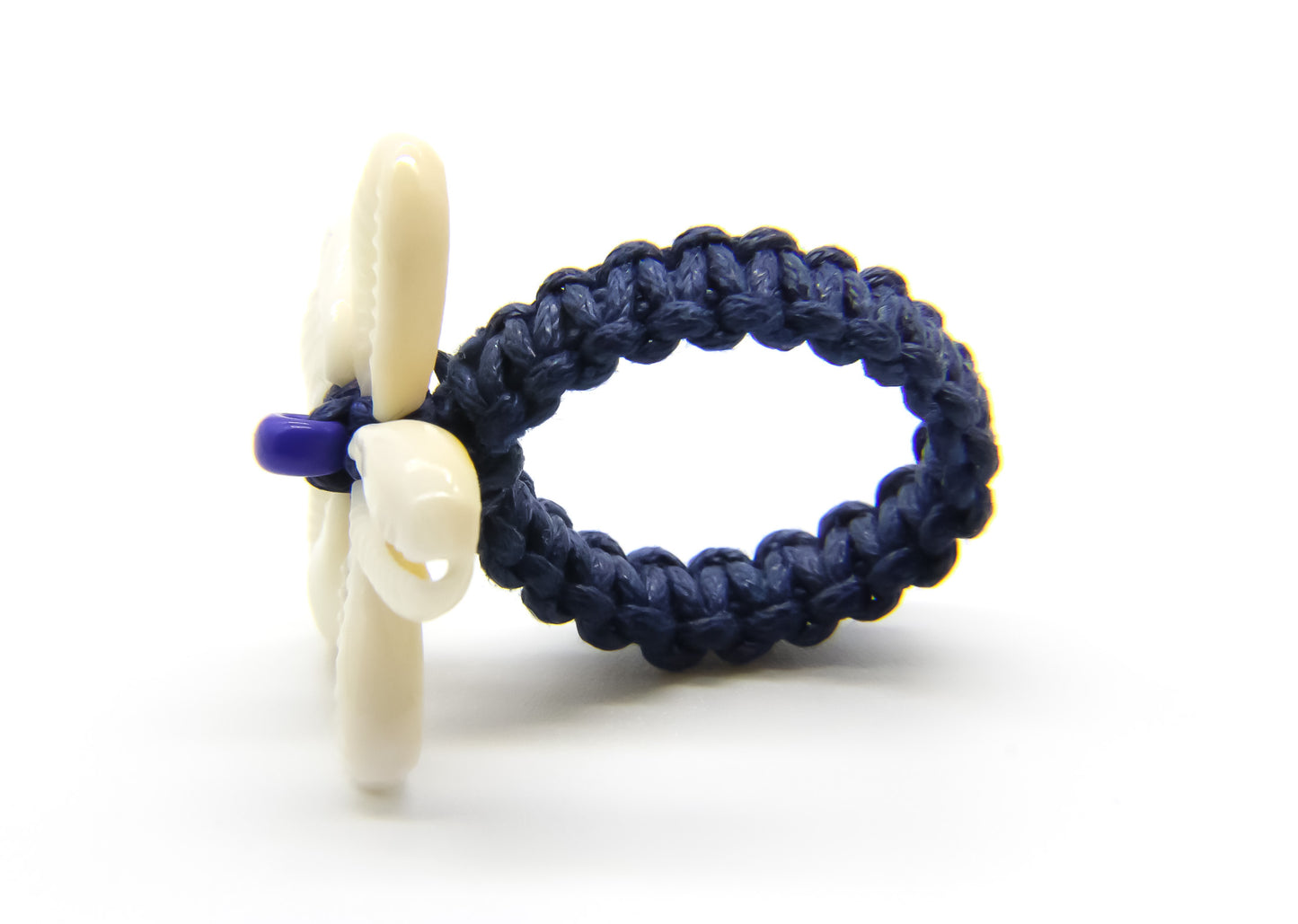 blue hemp ring with cowrie shells in the shape of a flower