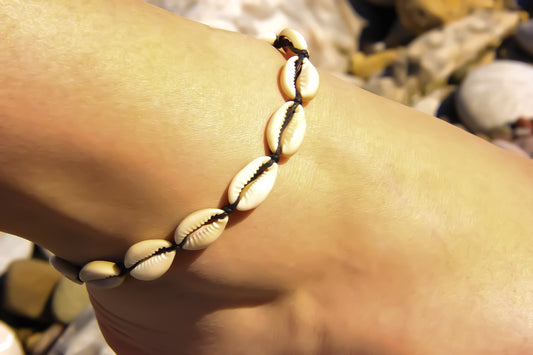 Model's foot wearing a seashell anklet 