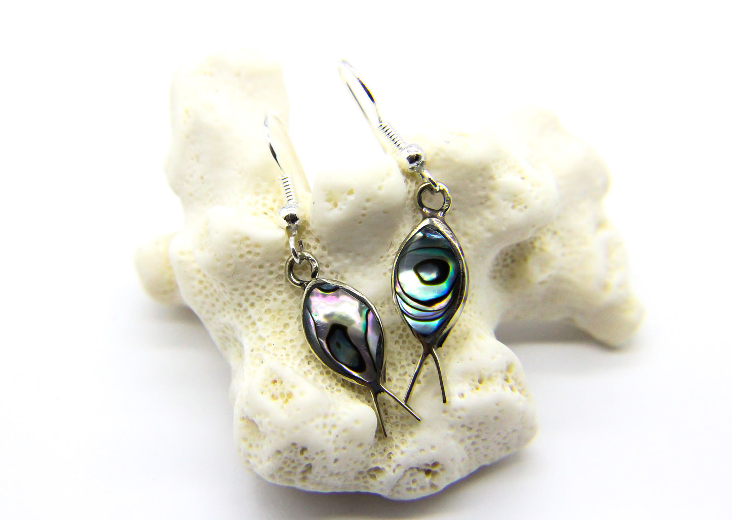 Silver fish earrings with shell inlay on a piece or coral 