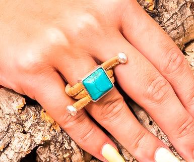 Model wearing cork ring with turquoise stone