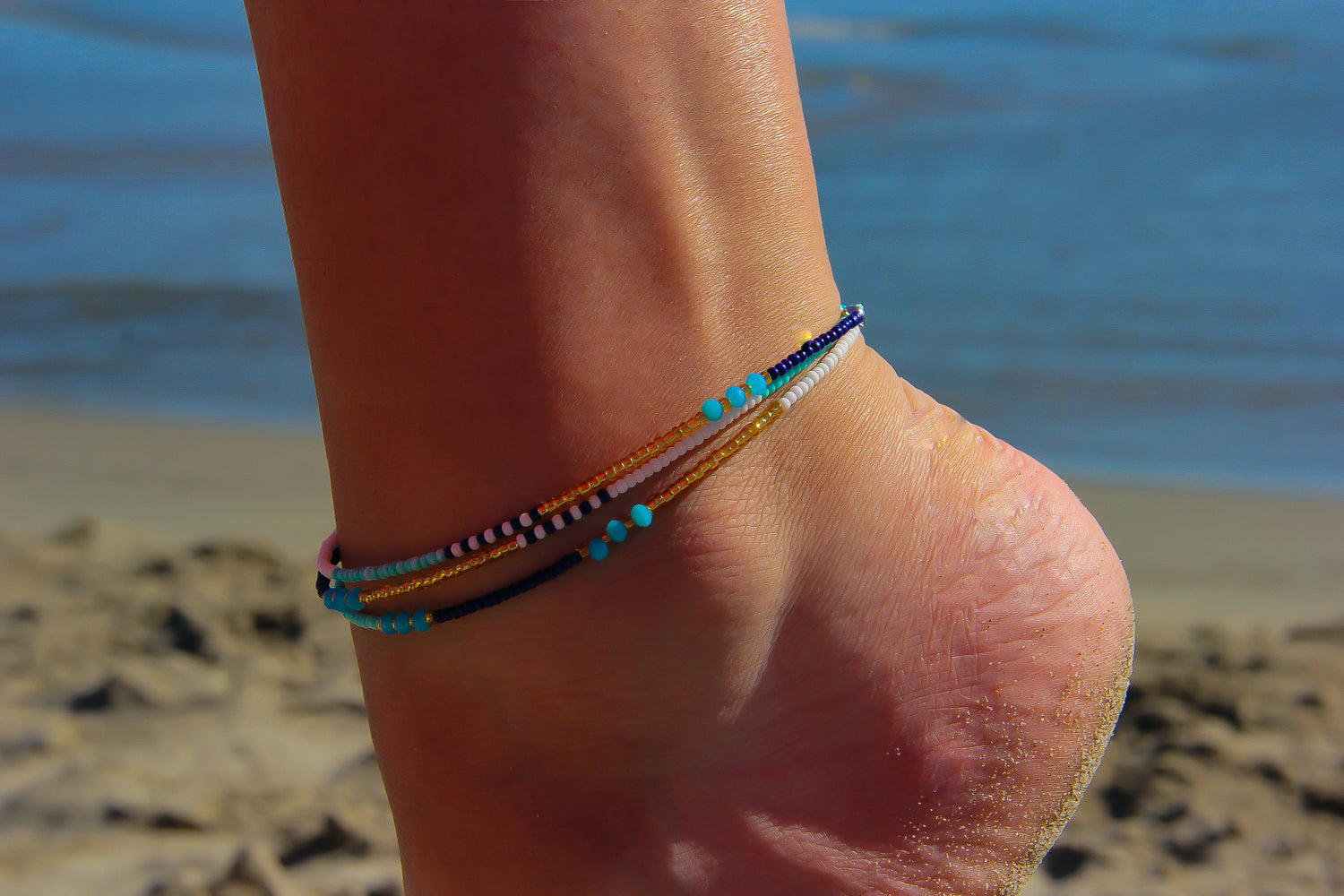 Multistrand Seed Bead Anklet on model's ankle with beach and sea in background