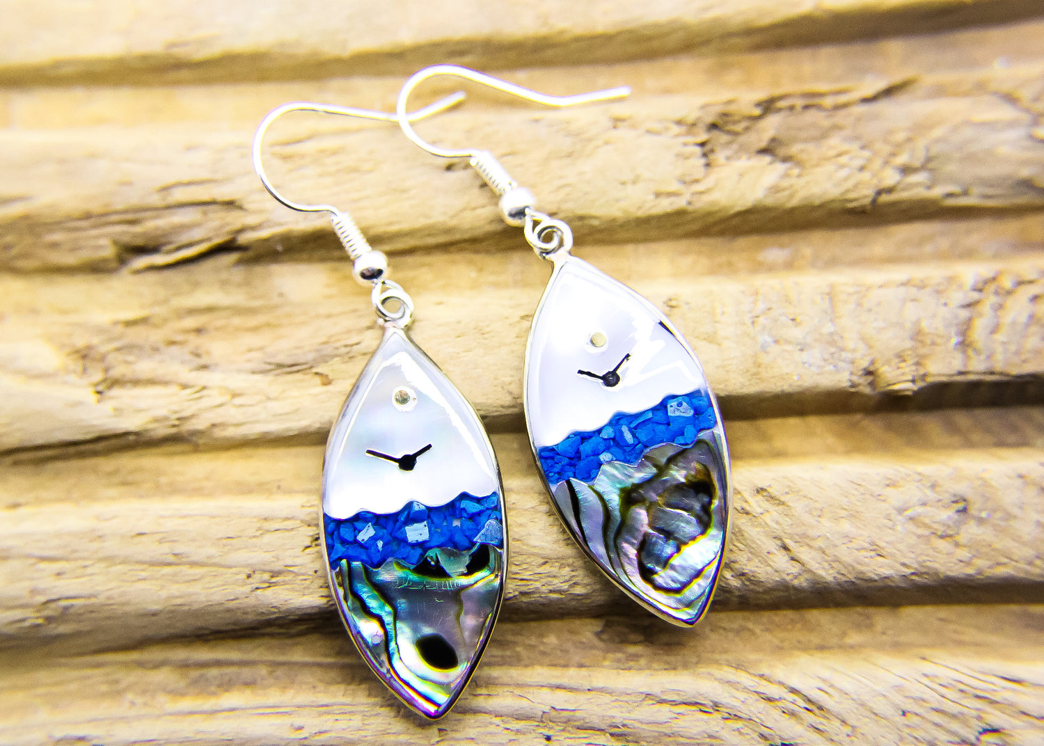 Oval shaped drop earrings featuring an ocean view design.