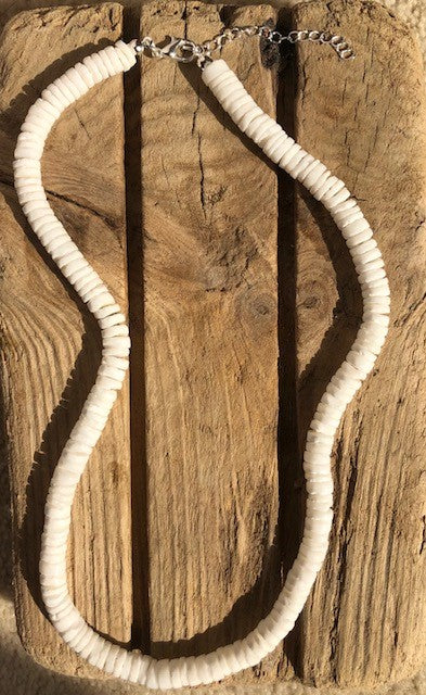 White shell choker with silver catch | Choker is on a piece of slatted wood