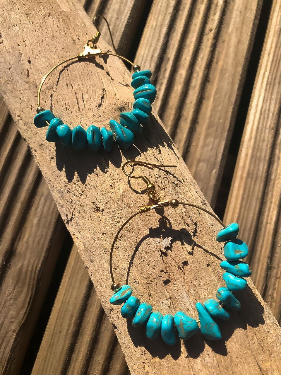 2 hoop earrings on driftwood with irregular turquoise stones