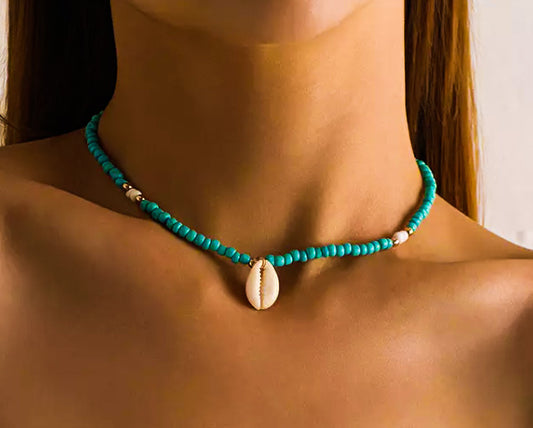 Model wearing blue beaded choker with cowrie shell