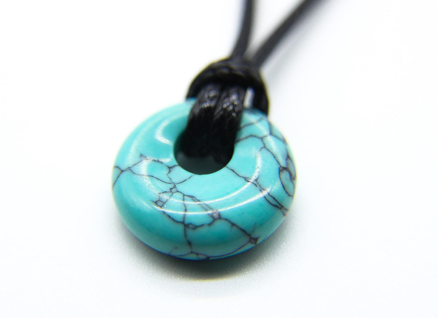 Turquoise pendant on a black cord choker  
