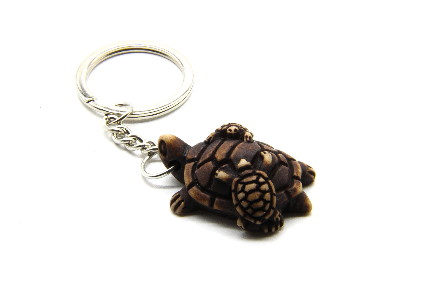 Keyring with adult sea turtle with baby sea turtles crawling all over its back. 