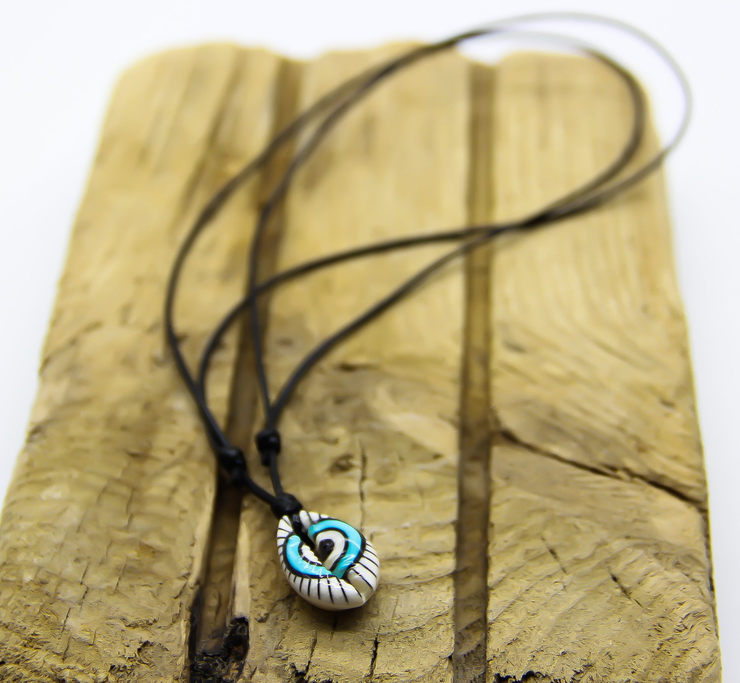 Black necklace with painted shell pendant